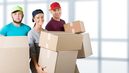 Professional movers handling furniture in a central London flat