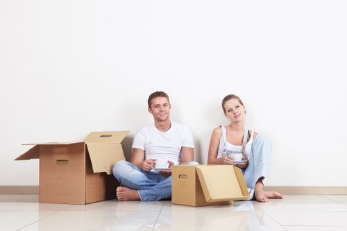 Professional movers carrying furniture through a central London property